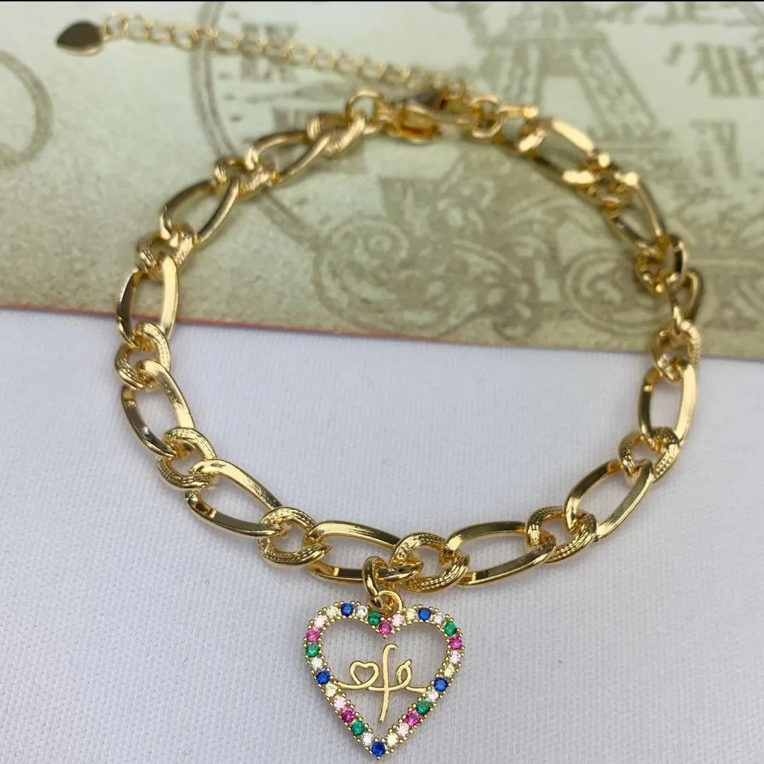 PULSEIRA DOURADA CORAÇÃO VAZADO FÉ CRAVEJADO EM MICROZIRCÔNIA MULTICOLORIDAS