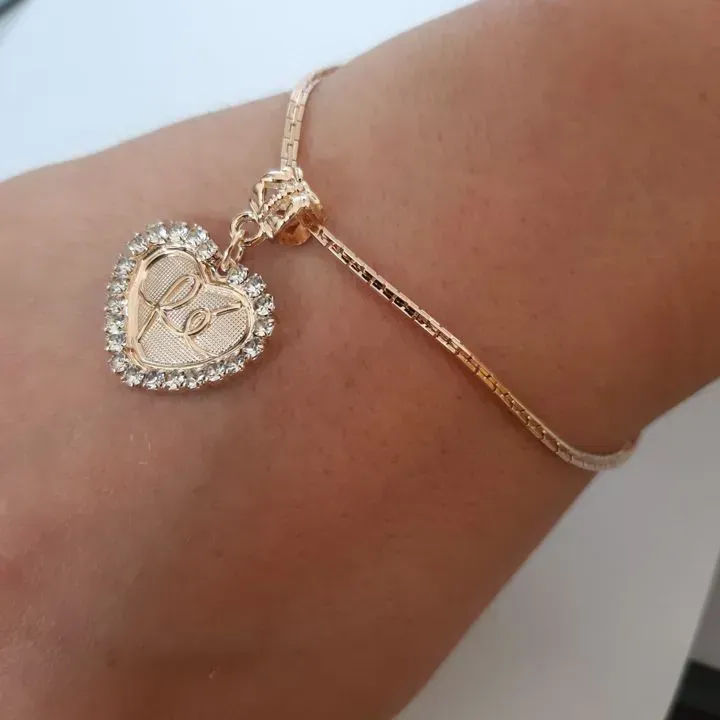 PULSEIRA DOURADA PINGENTE CORAÇÃO FÉ CRAVEJADO COM ZIRCÔNIAS CRISTAL